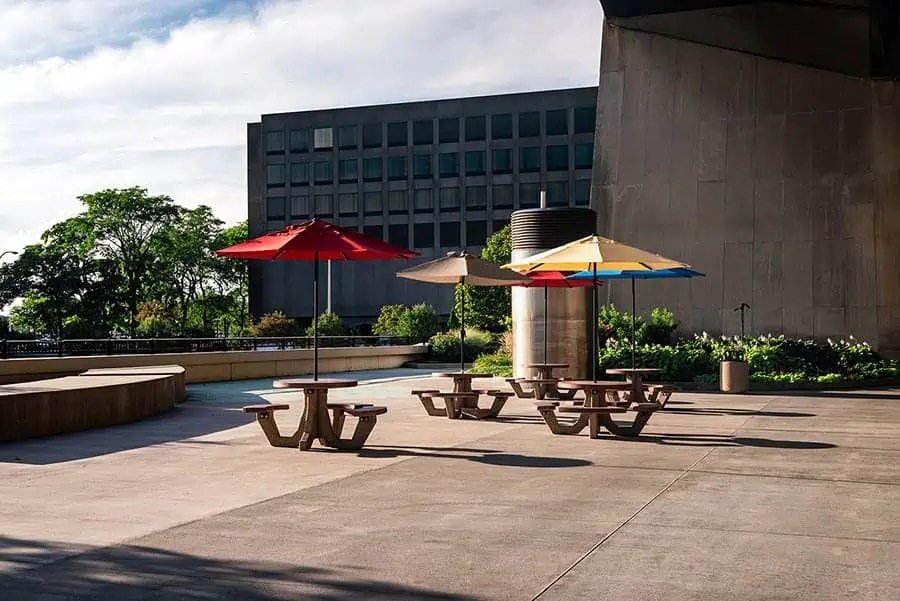 Outdoor seating area surrounded by professionally maintained landscaping